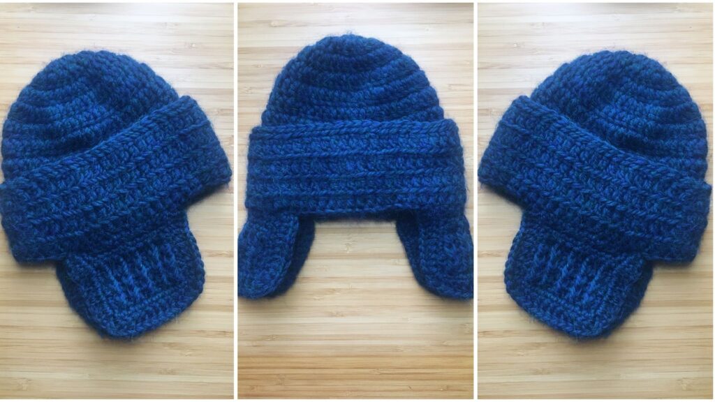 Three overhead photos lay side by side of a blue crochet baby hat with ear flaps resting on a light wooden background. The hat is seen from the laying on its left side, folded in the middle and then from the right side across the photo to show of the fancy ear flaps.