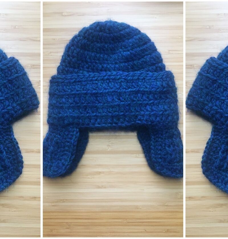 Three overhead photos lay side by side of a blue crochet baby hat with ear flaps resting on a light wooden background. The hat is seen from the laying on its left side, folded in the middle and then from the right side across the photo to show of the fancy ear flaps.